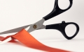 scissors cutting red tape