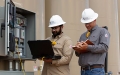 two men at oil tank