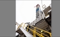 man climbing steps to drilling rig