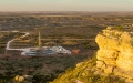 High cliff with drilling rig in background