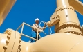 man holding steering wheel on top of pipeline