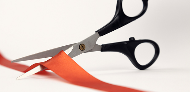 scissors cutting red tape