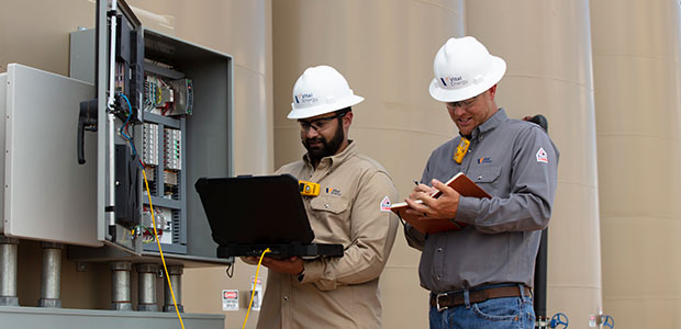 two men at oil tank