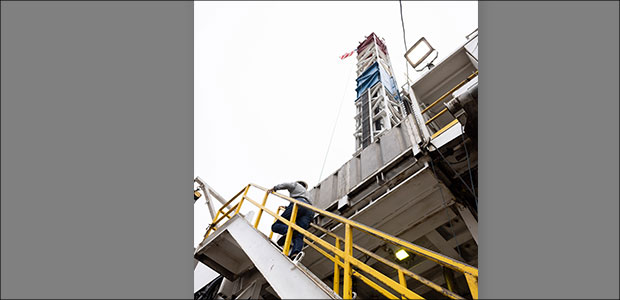 man climbing steps to drilling rig