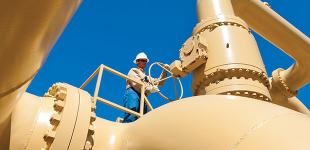 man holding steering wheel on top of pipeline