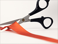 scissors cutting red ribbon