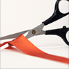 scissors cutting red tape