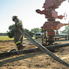 man with hose at wellhead