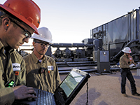 field workers on a laptap