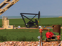 pumpjack with tank equipment in foreground