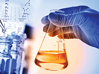 Flask in scientist's hand with laboratory background
